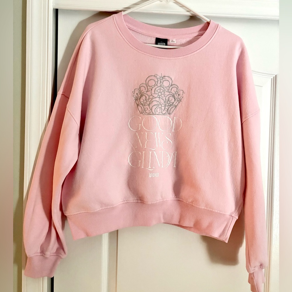 Wicked “Good News Glinda” Juniors Pink Crop Sweatshirt